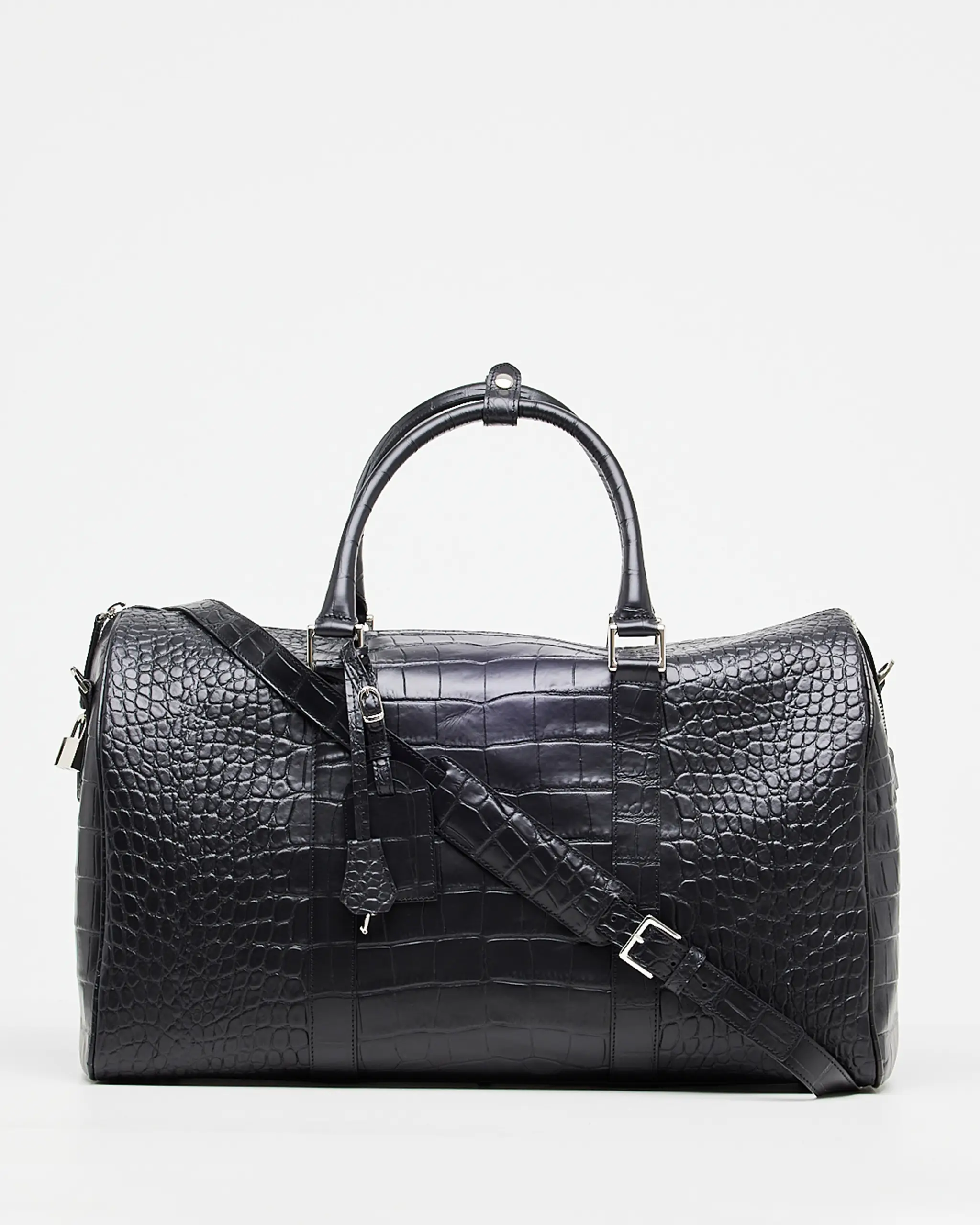 This stunning leather weekend travel bag is perfect for your next getaway. It features a Croco print that adds a touch of luxury and elegance. The roomy interior is perfect for packing all your essentials, and the adjustable strap makes it easy to carry. This classy duffle bag handmade in Italy with Tuscany calf leather and high-quality materials is completed with zipped compartments and card pockets.